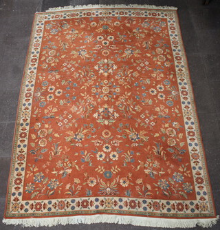 A 1930's peach and floral patterned machine made carpet 334cm x 242cm 
