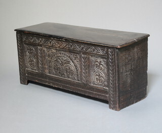 An 18th Century oak coffer of panelled construction with hinged lid and iron butterfly hinges 49cm h x 113cm w x 41cm d 