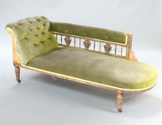 A Victorian carved oak showframe chaise longue with bobbin turned decoration, upholstered in buttoned green material 73cm h x 163cm w x 63cm d (seat 120cm x 50cm) 