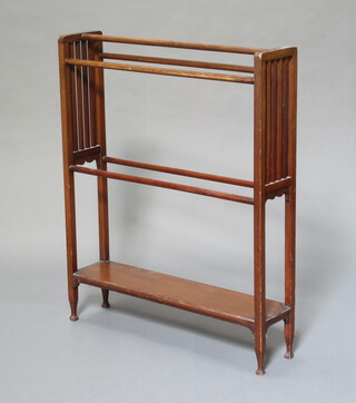 An Edwardian mahogany towel rail the base with undertier, raised on shaped supports 93cm x 76cm x 18cm 