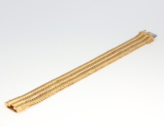 A yellow metal stamped 750 mesh bracelet 82.5 grams gross including the clasp, 15mm diameter, 18cm in length 