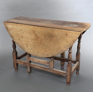 An 18th Century bleached oak gateleg dining table fitted a frieze drawer, raised on turned supports 72cm h x 108cm w x 40cm when closed x 107cm when open 