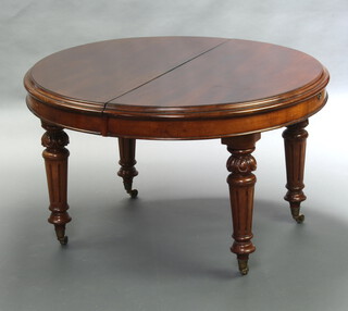 A Victorian mahogany extending dining table raised on turned and fluted supports with 2 extra leaves and winding handle 71cm h x 118cm w x 118cm x 240cm l when fully extended  
