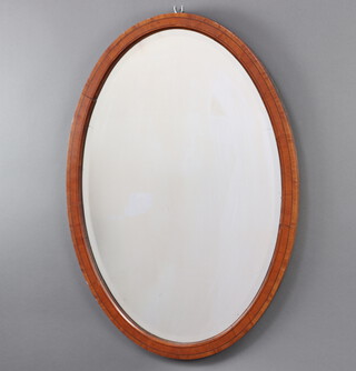 An Edwardian oval bevelled plate wall mirror contained in an inlaid mahogany frame 60cm x 85cm 