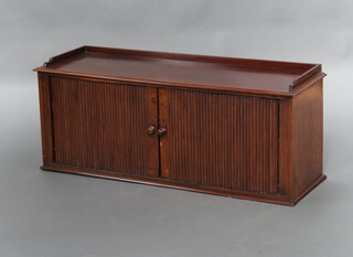 A 19th Century Continental mahogany table top cabinet, interior fitted pigeon holes enclosed by tambour shutters 43cm h x 106cm w x 35cm d  