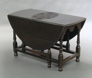 A 19th Century heavily carved oak oval gateleg drop flap dining table 71cm h x 125cm w x 55cm when closed x 145cm when open 