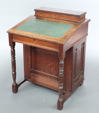 A late Victorian oak Davenport desk, the top with hinged stationery box, the pedestal with inlaid green leather writing surface and fitted 4 drawers, raised on turned supports 78cm h x 56cm w x 56cm d 