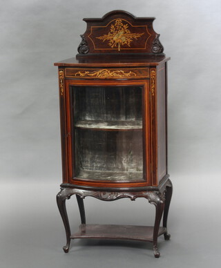 An Edwardian inlaid mahogany bow front display cabinet with arched shaped back and plush interior, fitted a drawer, raised on carved cabriole supports with undertier 124cm h x 43cm w x 40cm d 