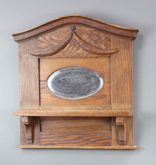 An Edwardian carved oak arch shaped bracket with bevelled plate panelled mirror to the back 50cm h x 50cm w x 11cm d 