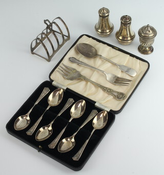 A silver 5 bar arched toast rack Sheffield 1931, 6 cased teaspoons, 2 forks, a spoon and 3 condiments 254 grams 