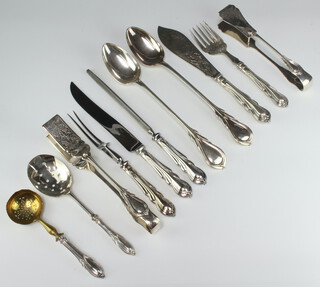 A quantity of lily pattern silver plated cutlery comprising 2 basting spoons, 2 serving spoons, asparagus tongs, carving knife, fork and steel, fish servers and a cake server 