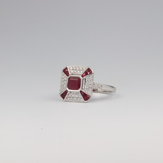 A white metal stamped 18k Art Deco style ruby and diamond square dress ring, the rubies 1.0ct, the brilliant cut diamonds 0.5ct, 4.4 grams, size N  