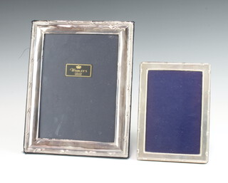 A modern silver ribbon and bow rectangular photograph frame 25cm x 20cm, a smaller ditto 18cm x 13cm 