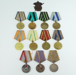A collection of Soviet Union medals comprising The Medal for Battle Merit (Russia), The Medal For the Liberation of Prague, The Medal For The Capture of Budapest and Medal For The Capture of Conixberg, The Medal For Distinguished Labour, The Medal For The Capture of Vienna, Medal For The Defence of Leningrad, Veteran of The Armed Forces of The USSR medal, Medal For The Liberation of Belgrade, Medal For The Defence of Caucasus and 30 Years of The Soviet Army and Navy, together with an associated badge   