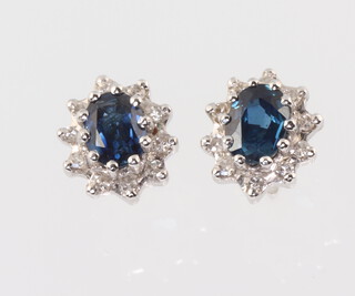 A pair of white metal stamped 18ct oval sapphire and diamond ear studs 10mm x 8mm, 2.2 grams 