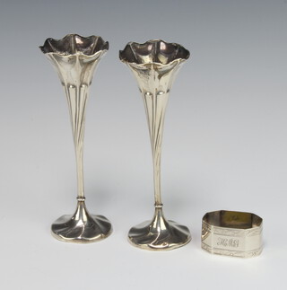 A pair of Edwardian silver spiral repousse posy vases Sheffield 1907, 16cm together with a silver napkin ring Birmingham 1926 