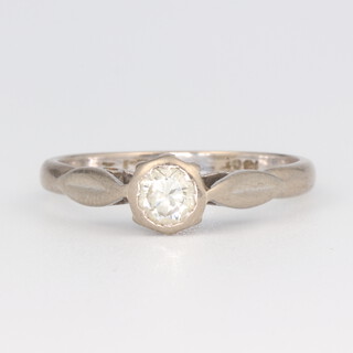 A white metal stamped 18k single stone diamond ring, approx. 0.25ct, size J 1/2, 2.6 grams