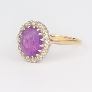 A yellow metal 18ct oval amethyst and diamond ring, size M 1/2, 3.2 grams
