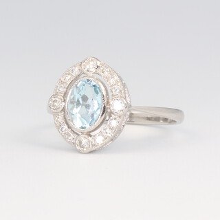 A white metal stamped Plat oval aquamarine and diamond ring, the centre stone 0.7ct, the brilliant cut diamonds 0.3ct, 3.6 grams, size M 1/2