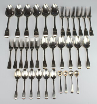 A quantity of silver fiddle pattern cutlery comprising 6 tablespoons, 6 dessert spoons, 6 teaspoons, 4 mustard spoons, 6 dinner forks, 6 dessert forks, mixed dates and makers, all engraved monogram M, 1550 grams 