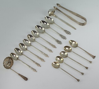 A pair of Georgian silver bright cut sugar nips, minor sifter spoons, teaspoons, coffee spoons 212 grams