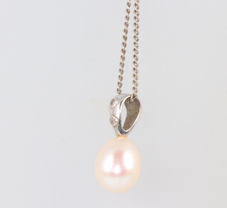 An 18ct white gold cultured pearl and diamond pendant 15mm, on a 40cm 9ct white gold chain 1.7 grams