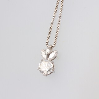A white metal diamond pendant comprising a single brilliant cut stone 1.0ct, colour F/G VVS2, suspended by a brilliant cut diamond and 2 elliptical diamonds 14mm x 7mm, 1 gram, hung on a 14ct white gold chain 2.8 grams 