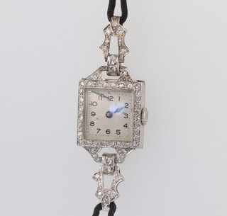 A lady's Art Deco white metal stamped Plat. cocktail watch, contained in a diamond set case on a cotton strap 15mm x 18mm 