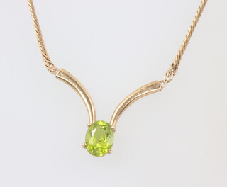 A 9ct yellow gold necklace set with an oval peridot 5.8 grams 