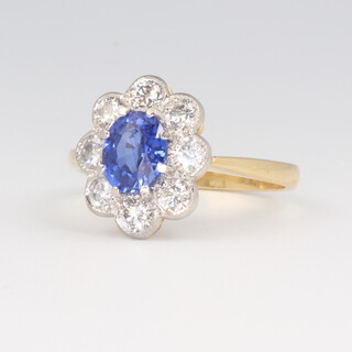 A yellow metal stamped 18k oval sapphire and diamond ring, the centre stone 1.35ct, the 8 brilliant cut diamonds 0.8ct, size O 1/2, 4.5 grams