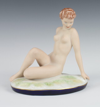 A Royal Dux matt glazed figure of a seated naked lady on an oval base 711 45 21cm 