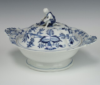 A 19th Century Meissen blue and white 2 handled bowl and cover with figure of a kneeling boy finial holding a cornucopia, profusely decorated with flowers and fruit with floral handles 32cm 