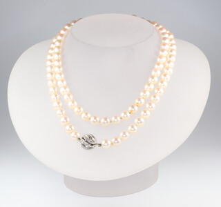 A strand of 92 cultured pearls with a white metal stamped 585 diamond ball clasp, 73cm, pearls each approx. 6mm 