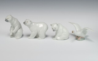 A Lladro figure of a seated polar bear 13cm, a ditto 9cm, a walking ditto 10cm and a goose 12cm 