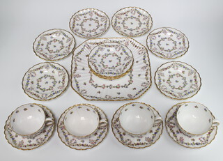 An Edwardian Copeland tea set retailed by Goode & Co comprising 4 tea cups, 4 saucers, 9 small plates and 1 sandwich plate, profusely decorated with swags and flowers 