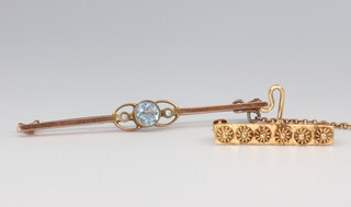 A yellow metal stamped 18k pin 2.3 grams together with a yellow metal topaz and seed pearl bar brooch 