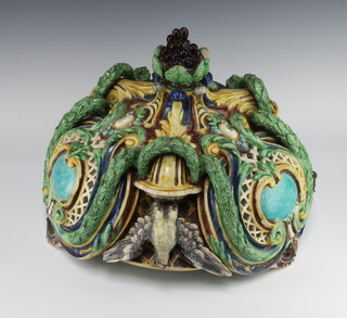 A Victorian Minton style Majolica light fitting, the pierced body decorated with green birds with outstretched wings among floral swags and terminating in a grape finial, unmarked 45cm, suspended on metal chains 