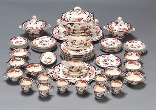 A Masons Ironstone Mandalay pattern dinner service comprising 8 tea cups (1 a/f), 8 saucers, 8 two handled bowls (3 a/f) and 8 saucers (1 a/f), 8 small plates, 8 medium plates (1 a/f), 8 dinner plates (1 a/f), soup tureen and cover, 2 vegetable tureens and covers, 2 sauce boats (1 a/f), 2 sauce boat stands, a serving plate and a meat plate 