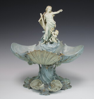 A 19th Century Continental bisque centrepiece with a lady and attendant standing on a shell scalloped bowl with scalloped base and shells 40cm 