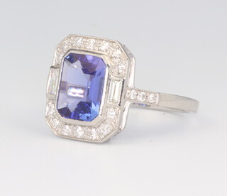 A white metal stamped Plat tanzanite and diamond ring, the emerald cut tanzanite 2.2ct, the brilliant and baguette cut diamonds 0.4ct, size M 1/2, 4.9 grams