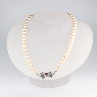 A strand of 45 cultured pearls each approx. 6mm with a white metal stamped 750 ruby and diamond clasp, 41cm  