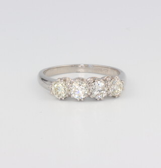 A white metal stamped Plat. 4 stone diamond ring approx. 1.25ct, 4.6 grams, size N 1.2