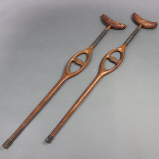 A pair of sprung loaded mahogany leather and metal crutches 124cm h x 21cm w x 4cm d