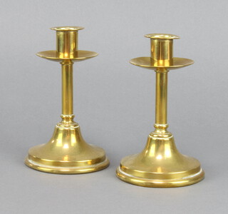 A pair of Victorian brass candlesticks with shaped sconces 15cm h x 10cm diam. 