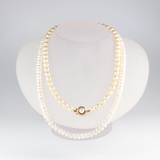 A cultured pearl necklace with a 9ct yellow gold clasp together with a freshwater cultured ditto and a pair of yellow metal earrings 