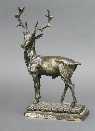 A cast metal door stop in the form of a stag, raised on a rectangular base 30cm h x 17cm w x 7cm d 