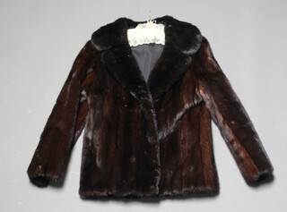A lady's quarter length black fur jacket 