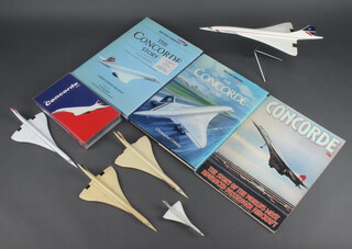 A plastic model aircraft of Concorde 14cm x 15cm x 32cm (pitted to the edges of the wings) and 4 other models of Concorde, Christopher Orlebar, sixth edition "The Concorde Story" signed, ditto "Concorde Story Ten Years in Service", a Concorde magazine and a video 

