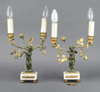 A pair of 19th Century gilt ormolu and bronze twin light candelabrum converted to table lamps, supported by a figure of pan and a faun playing a triangle, raised on white marble bases 45cm h x 8cm w x 8cm d 