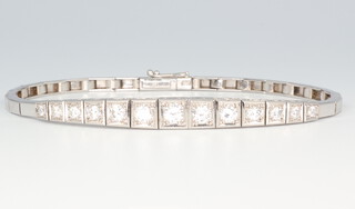 A white metal stamped 750 graduated 13 stone diamond bracelet, approx. 1.5ct, 17.5cm in length 14.2 grams 